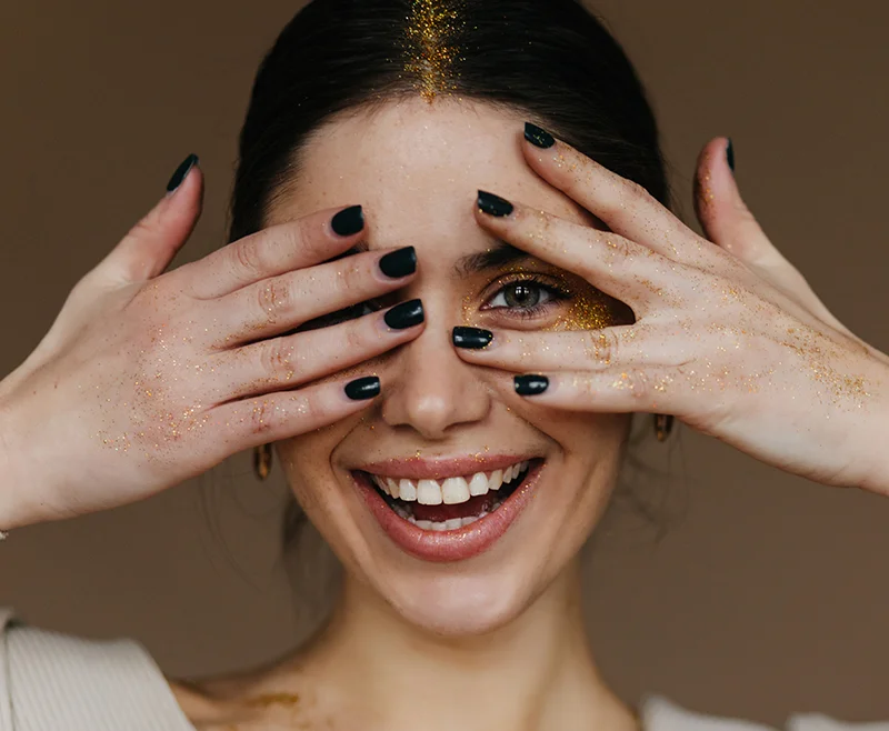 Amazing girl with party makeup posing with happy smile close up