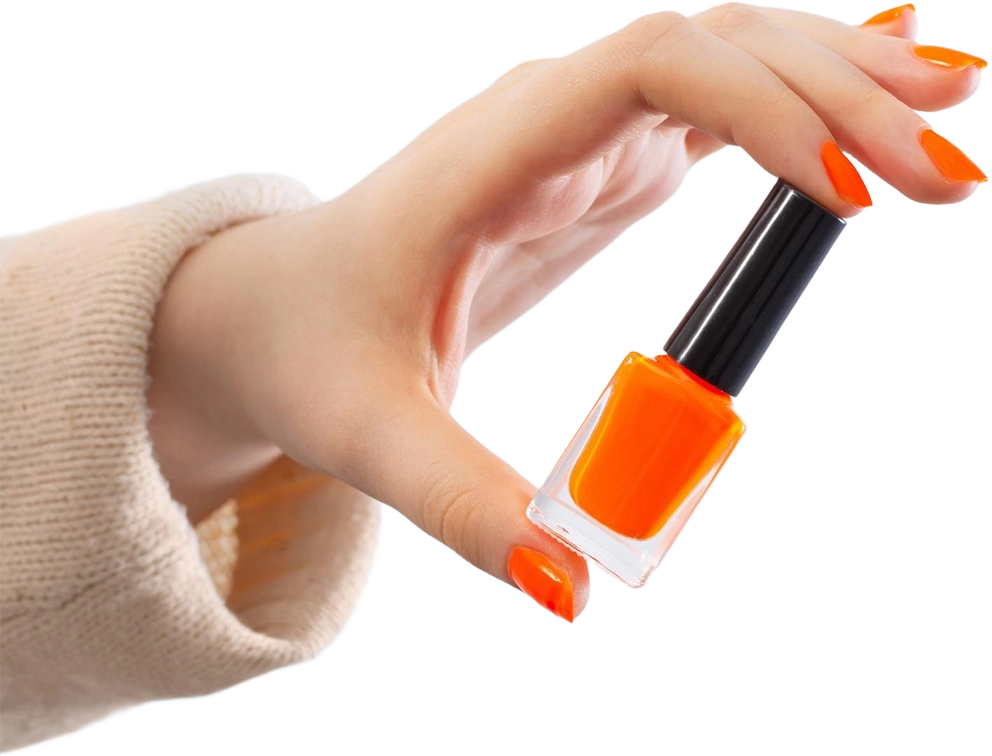 Female hands with orange manicure with nail polish bottle