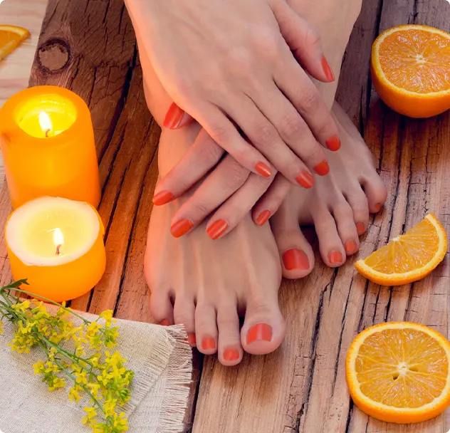 Orange manicure around oranges and candles